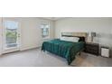 Bright bedroom featuring a large window, a comfy bed, and a door leading to the exterior at 4724 Electric Sw Ave, Mableton, GA 30126
