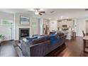 Open-concept living room featuring a fireplace, ceiling fan, and hardwood floors at 4724 Electric Sw Ave, Mableton, GA 30126