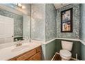 Half bathroom features decorative wallpaper, a modern sink, and an updated toilet at 5170 Ridge Tarn, Acworth, GA 30102