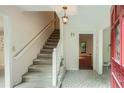 Inviting foyer with stairs, tile flooring, and an open doorway, adjacent to the red front door at 2034 Starfire Ne Dr, Atlanta, GA 30345
