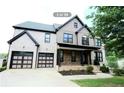 Two-story house features a two-car garage and a well-maintained lawn at 3306 Chastain Ridge Dr, Marietta, GA 30066