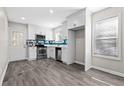Stylish eat-in kitchen featuring stainless steel appliances, white cabinets, luxury vinyl plank flooring, and tiled backsplash at 4064 Post Rd, Winston, GA 30187