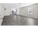 Spacious living room features modern gray wood flooring, neutral paint, and bright windows at 4064 Post Rd, Winston, GA 30187