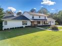 Stunning exterior view of a two-story home with a large lawn and well-maintained landscaping at 1435 Willis Lake Nw Dr, Kennesaw, GA 30152