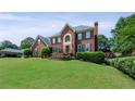 Charming brick residence featuring a well-maintained lawn and lovely shrubbery, creating an inviting outdoor space at 3331 Lockwood Sw Ct, Lilburn, GA 30047