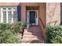 Welcoming front entrance featuring brick steps, a black front door, and established landscaping at 45 Paces West Nw Dr, Atlanta, GA 30327
