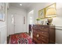 Bright foyer with hardwood floors, elegant dresser, and natural light from the front door at 45 Paces West Nw Dr, Atlanta, GA 30327