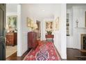 Elegant foyer with hardwood floors, a decorative rug, and classic furnishings at 45 Paces West Nw Dr, Atlanta, GA 30327