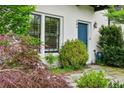 Charming home entrance with blue front door, flagstone walkway, lush landscaping, and decorative address numbers at 584 Bismark Ne Rd, Atlanta, GA 30324