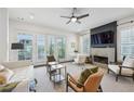 Light-filled living room with fireplace, French doors, neutral decor, and modern ceiling fan at 584 Bismark Ne Rd, Atlanta, GA 30324