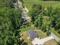 Beautiful aerial view of wooded lot with a long driveway, surrounded by lush greenery and trees at 165 6Th St, Auburn, GA 30011