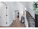 Bright and open foyer with hardwood floors and a staircase with decorative iron railings at 165 6Th St, Auburn, GA 30011