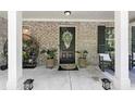 Inviting front porch with potted plants and rocking chairs creating a cozy outdoor space at 165 6Th St, Auburn, GA 30011