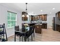 Eat-in kitchen showcases granite counters, recessed lighting, stainless appliances and a dining area near a large window at 165 6Th St, Auburn, GA 30011