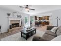 Inviting living room boasts a brick fireplace, ceiling fan, and an open floor plan to the kitchen at 165 6Th St, Auburn, GA 30011