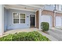 Inviting front porch featuring brick accents, and a well-manicured shrub, creating a warm welcome at 2331 Suwanee Pointe Dr, Lawrenceville, GA 30043