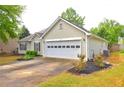 Charming single-story home featuring well-maintained lawn, neat shrubbery, and convenient two-car garage at 604 Lexington Way, Woodstock, GA 30189