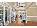 Elegant foyer featuring hardwood floors, staircase with iron railings, and views to other living spaces at 902 Preserve Bluff Dr, Buford, GA 30518