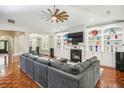 Spacious living room featuring built-in shelving, a cozy fireplace, and an expansive sectional sofa at 1055 Chelsey Way, Roswell, GA 30075