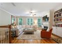 Inviting living room with hardwood floors, large sectional, and built-in shelving at 11187 Calypso Dr # 12, Alpharetta, GA 30009