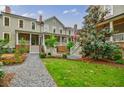 Beautiful townhomes showcase landscaped front yards and inviting covered front porches at 1076 Green St, Roswell, GA 30075