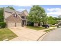 Suburban home with a long driveway, two car garage, and manicured lawn at 1529 Shiloh Manor Ct, Marietta, GA 30066