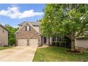 Beautiful two-story home with brick and siding, featuring a well-kept lawn and spacious driveway at 1529 Shiloh Manor Ct, Marietta, GA 30066