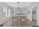 Inviting dining area with large windows, modern chandelier, and convenient access to the kitchen and living spaces at 345 Wellington Sw St, Atlanta, GA 30310