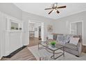 Bright living room with stylish furnishings, a decorative fireplace, and an open view to the dining and kitchen areas at 345 Wellington Sw St, Atlanta, GA 30310