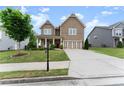 Charming two-story home featuring a covered porch and a well-maintained lawn at 5920 Hart Way, Cumming, GA 30028