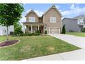 Charming two-story home featuring a covered porch and a well-maintained lawn at 5920 Hart Way, Cumming, GA 30028