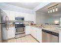Bright kitchen with stainless steel appliances, granite countertops, and ample cabinet space at 1850 Cotillion Dr # 4306, Dunwoody, GA 30338