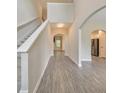Inviting hallway features gray vinyl flooring and archways that lead to other rooms in the home at 2534 Grayton Loop, Villa Rica, GA 30180