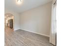 Open-concept room features gray vinyl floors, neutral walls, and a view into an adjacent kitchen at 2534 Grayton Loop, Villa Rica, GA 30180