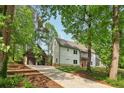 Spacious house surrounded by mature trees and a long concrete driveway at 4840 Moon Rd, Powder Springs, GA 30127