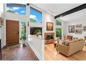 Bright living room with hardwood floors, a stone fireplace, and large windows offering great natural light at 5148 Stratham Dr, Dunwoody, GA 30338
