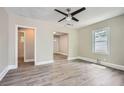 Bright living room featuring modern ceiling fan, hardwood floors, and fresh neutral paint at 1002 Ira Sw St, Atlanta, GA 30310