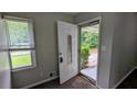 Inviting entryway showcasing a decorative front door, window, and neutral paint color at 1091 Luther Sw Dr, Mableton, GA 30126