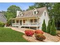 Charming home with a cozy front porch, colorful plants, and inviting curb appeal at 1768 San Andra Dr, Marietta, GA 30062