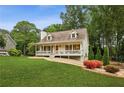 Lovely cape cod home with a welcoming front porch and vibrant landscaping at 1768 San Andra Dr, Marietta, GA 30062