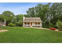 Inviting single-Gathering home with a rocking chair front porch and lush greenery at 1768 San Andra Dr, Marietta, GA 30062