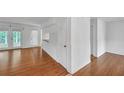 Bright living room featuring hardwood floors, a door to a deck, and neutral paint at 4440 Coventry Ne Ct, Roswell, GA 30075
