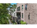 Street view of modern brick townhouses with balconies and landscaped sidewalks, blending urban living with nature at 1626 Aldworth Se Pl, Atlanta, GA 30339