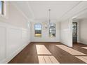 Bright dining room with hardwood floors, wainscoting and modern chandelier at 739 Marlay Sw Ln, Powder Springs, GA 30127