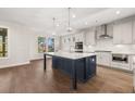 Bright kitchen featuring a large island, stainless steel appliances, and hardwood floors at 739 Marlay Sw Ln, Powder Springs, GA 30127
