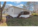 Charming home featuring a cozy front porch with stairs and well-maintained landscaping at 91 East Meadow Ln, Conyers, GA 30012