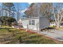 View of a well-kept home with a driveway, inviting front porch, and attractive lawn at 91 East Meadow Ln, Conyers, GA 30012