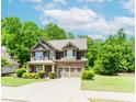 Inviting two-story home with a lush lawn, complemented by an attached two-car garage and plentiful natural light at 674 Chadmon Court Trce, Dacula, GA 30019