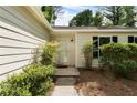 Well-kept front entrance showing landscaping and neutral siding and trim at 102 River Oaks Dr, Woodstock, GA 30188