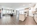 Spacious open-concept living area with modern kitchen featuring stainless steel appliances and island at 316 Denali Butte Ter, Canton, GA 30114